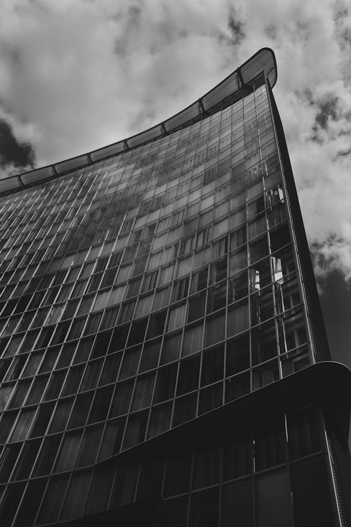 Black and white photo of a modern glass building in Hamburg, Germany showcasing contemporary architecture.